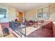 Cozy front porch featuring brick walls, a tiled floor, and charming iron railing, and outdoor furniture at 5055 W 33Rd Ave, Denver, CO 80212