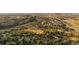 Scenic aerial view of a beautiful community with lush greenery, golf course, and houses at 7649 Pineridge Ter, Castle Pines, CO 80108