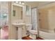 Bathroom featuring a pedestal sink, toilet and bath tub with shower at 7649 Pineridge Ter, Castle Pines, CO 80108