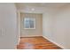 Bedroom with wood floors and a small window at 7649 Pineridge Ter, Castle Pines, CO 80108