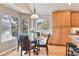 Bright breakfast nook with a glass table, wood floors, and large windows offering natural light and scenic views at 7649 Pineridge Ter, Castle Pines, CO 80108