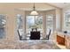 Sunlit breakfast nook featuring a glass table, corner windows with views, and a kitchen island with stone countertops at 7649 Pineridge Ter, Castle Pines, CO 80108