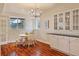 Sunny dining area with a white table, chandelier and large windows at 7649 Pineridge Ter, Castle Pines, CO 80108