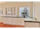 Bright dining area, showing cabinets, large windows and a sink at 7649 Pineridge Ter, Castle Pines, CO 80108