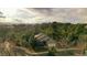 A home nestled within a lush, tree-filled community, beautiful landscaping, and scenic mountain views at 7649 Pineridge Ter, Castle Pines, CO 80108