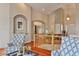 Bright and airy foyer featuring hardwood floors, an archway, and an abundance of natural light at 7649 Pineridge Ter, Castle Pines, CO 80108