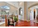 Spacious foyer featuring hardwood floors, elegant architectural details, and plentiful natural light at 7649 Pineridge Ter, Castle Pines, CO 80108