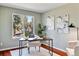 Inviting home office with a modern desk, comfortable chair, and a window offering natural light and wooded views at 7649 Pineridge Ter, Castle Pines, CO 80108