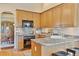 Cozy kitchen with light wood cabinetry, granite countertops, and stainless steel appliances at 7649 Pineridge Ter, Castle Pines, CO 80108