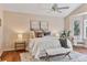 Serene main bedroom with a seating area, plush bedding, and a ceiling fan for added comfort at 7649 Pineridge Ter, Castle Pines, CO 80108