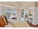 Comfortable main bedroom with a cozy sitting area, ample natural light, and built-in shelving for storage at 7649 Pineridge Ter, Castle Pines, CO 80108