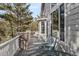 Inviting outdoor porch with stone pillars and comfortable seating area at 7649 Pineridge Ter, Castle Pines, CO 80108