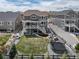 Expansive backyard with a trampoline, fire pit area, lush lawn, and spacious patio at 23879 E Narrowleaf Pl, Aurora, CO 80016