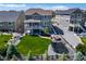 Expansive backyard with lush lawn, patio, fire pit, and trampoline, perfect for outdoor living and entertaining at 23879 E Narrowleaf Pl, Aurora, CO 80016