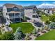 Aerial view of the backyard featuring a well-manicured lawn, firepit, trampoline, and patio at 23879 E Narrowleaf Pl, Aurora, CO 80016