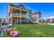Expansive backyard features a spacious deck, lush lawn, and a charming playhouse at 23879 E Narrowleaf Pl, Aurora, CO 80016