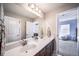 Elegant bathroom boasting double sinks with white countertops and a view into a relaxing bedroom at 23879 E Narrowleaf Pl, Aurora, CO 80016