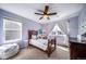 Cozy bedroom with a wooden bed frame, butterfly wall decor, and a soft, inviting aesthetic at 23879 E Narrowleaf Pl, Aurora, CO 80016