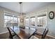 Dining area with large windows and modern lighting fixture above the table at 23879 E Narrowleaf Pl, Aurora, CO 80016