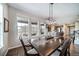 Dining room featuring modern lighting and access to the kitchen and deck at 23879 E Narrowleaf Pl, Aurora, CO 80016