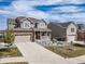 Charming two-story home with a well-manicured lawn, stone accents, and a two-car garage at 23879 E Narrowleaf Pl, Aurora, CO 80016