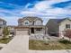 Charming two-story home featuring stone accents, a well-maintained lawn, and a two-car garage at 23879 E Narrowleaf Pl, Aurora, CO 80016