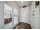 Inviting foyer featuring hardwood floors and direct access to the office through elegant glass doors at 23879 E Narrowleaf Pl, Aurora, CO 80016