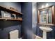 Stylish half bathroom with modern fixtures, wood shelving, and a unique sink at 23879 E Narrowleaf Pl, Aurora, CO 80016