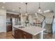 Open kitchen with a large island, stainless steel appliances, and seamless access to the staircase at 23879 E Narrowleaf Pl, Aurora, CO 80016
