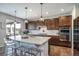 Bright, open kitchen with a large island, stainless steel appliances, and access to outdoor dining at 23879 E Narrowleaf Pl, Aurora, CO 80016