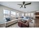 Bright and spacious living room with lots of windows and a large sectional at 23879 E Narrowleaf Pl, Aurora, CO 80016