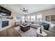 Comfortable living room featuring a stone fireplace and large sectional sofa at 23879 E Narrowleaf Pl, Aurora, CO 80016