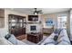 Inviting living room with fireplace, built-in shelving, and a ceiling fan at 23879 E Narrowleaf Pl, Aurora, CO 80016