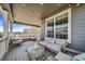 Relaxing covered patio showcasing comfortable seating and stylish decor, ideal for enjoying the outdoors at 23879 E Narrowleaf Pl, Aurora, CO 80016