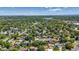 Scenic aerial view of the home in a neighborhood with abundant trees and nearby lake at 8272 Ammons Cir, Arvada, CO 80005