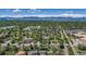 Scenic aerial view of a residential area with mature trees and distant lake views, promising a serene living environment at 8272 Ammons Cir, Arvada, CO 80005