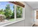 Window view of backyard with lush greenery, a playground, and a peek into the adjacent bathroom at 8272 Ammons Cir, Arvada, CO 80005