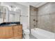 Well-lit bathroom featuring a shower over the tub, a modern sink, and plenty of storage space at 8272 Ammons Cir, Arvada, CO 80005