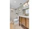 Stylish bathroom with a double vanity, walk-in shower, and modern fixtures at 8272 Ammons Cir, Arvada, CO 80005