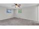 Inviting bedroom with carpet, windows offering natural light, and a ceiling fan for comfortable air circulation at 8272 Ammons Cir, Arvada, CO 80005