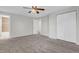 Bedroom featuring a ceiling fan, neutral walls, and a bathroom and closet that maximizes space and functionality at 8272 Ammons Cir, Arvada, CO 80005