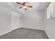 Clean bedroom with ceiling fan and window with a view; it features a large closet with sliding doors at 8272 Ammons Cir, Arvada, CO 80005