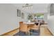 Stylish dining room with hardwood floors, modern lighting, and comfortable seating for four at 8272 Ammons Cir, Arvada, CO 80005