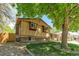 Well-kept home featuring a brick and siding exterior, landscaped yard, and mature shade trees at 8272 Ammons Cir, Arvada, CO 80005