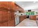 Well-appointed kitchen with wood cabinets, stainless steel appliances, and granite countertops at 8272 Ammons Cir, Arvada, CO 80005