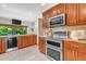 Modern kitchen featuring stainless steel appliances, granite countertops, and ample cabinet space at 8272 Ammons Cir, Arvada, CO 80005