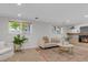Spacious living room with fireplace, large windows, and neutral tones, creating a warm and inviting atmosphere at 8272 Ammons Cir, Arvada, CO 80005
