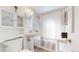 Classic bathroom featuring a pedestal sink, combination shower and tub, and built in storage at 6330 E 13Th Ave, Denver, CO 80220