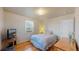 Cozy bedroom featuring hardwood floors, a window with blinds, and neutral decor at 6330 E 13Th Ave, Denver, CO 80220