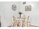 Bright dining area features a round wooden table and white chairs, perfect for casual meals at 6330 E 13Th Ave, Denver, CO 80220